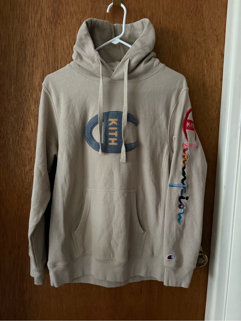 Kith and Champion Collab Beige Hoodie with Multicolor Sleeve Logo